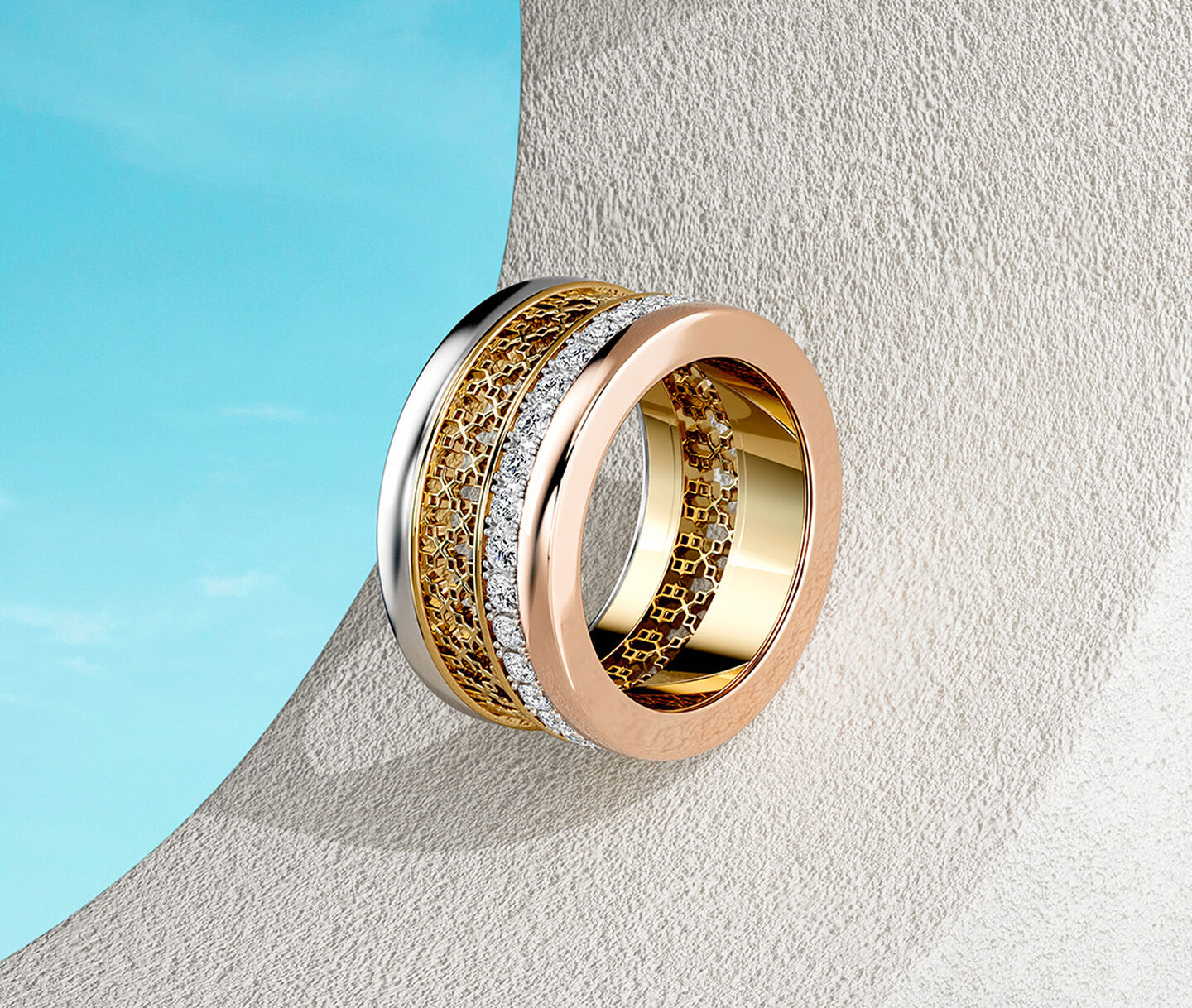Birks Dare to Dream tri-gold ring on a sky background.